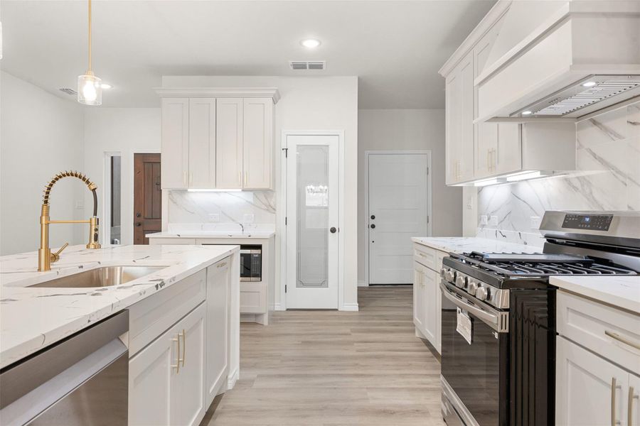 A contemporary kitchen features sleek countertops, stylish cabinetry, and modern appliances. A contemporary kitchen features sleek countertops, stylish cabinetry, and modern appliances.