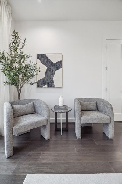Tranquil bedroom setting enhanced by soft natural light and a cohesive neutral palette. The spacious layout and elevated ceiling height contribute to an airy ambiance, while the seamless connection to the en-suite bath reinforces comfort and convenience within this private third-floor sanctuary.