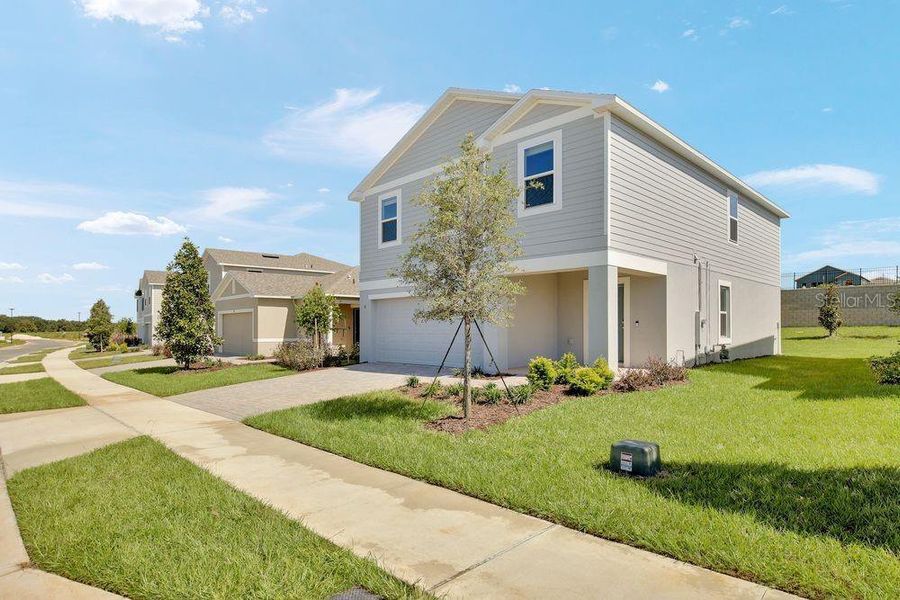 Front exterior of a new home in Waterstone, Groveland, FL, highlighting curb appeal (Image 1). Front exterior of a new home in Waterstone, Groveland, FL, highlighting curb appeal (Image 1).