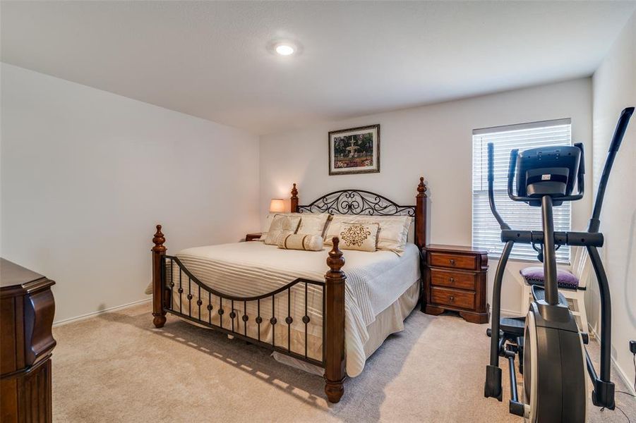 Bedroom featuring light colored carpet