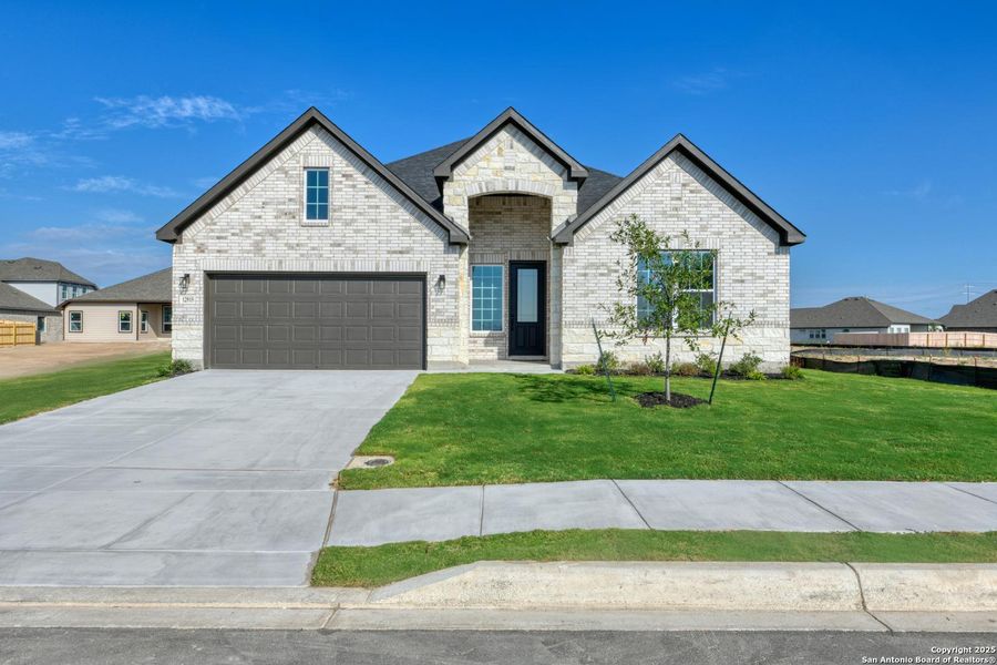 Front exterior of a new home in The Heritage at Saddlebrook Ranch 70's, Schertz, TX, highlighting curb appeal (Image 1). Front exterior of a new home in The Heritage at Saddlebrook Ranch 70's, Schertz, TX, highlighting curb appeal (Image 1).