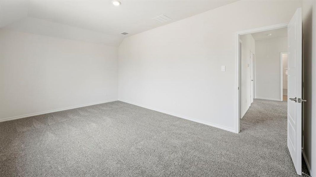 Bonus room with light colored carpet, lofted ceiling, and recessed lighting