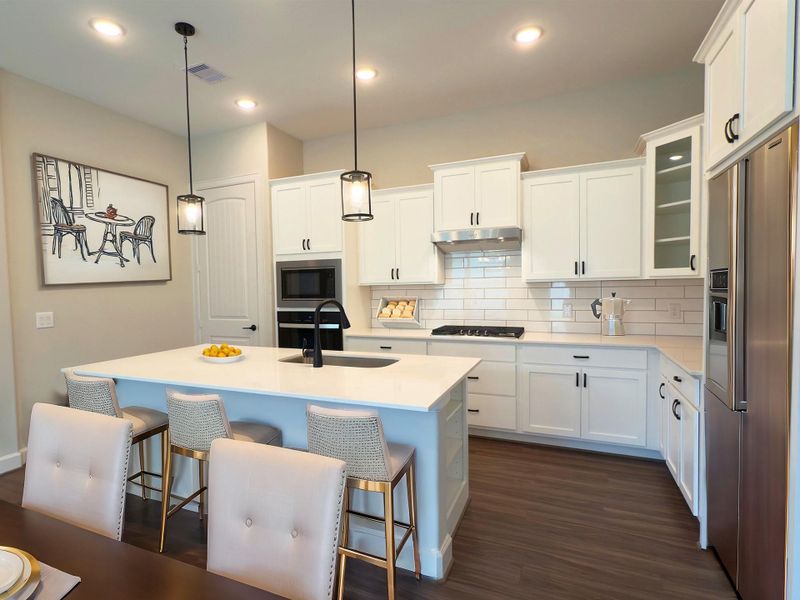 Experience Culinary excellence in the kitchen at Winfrey Estates, where state-of-the-art appliances meet sophisticated design. This gourmet space boasts expansive countertops, stylish cabinetry, and top-of-the-line fixtures, creating an ideal environment for both casual meals and lavish entertaining. *Image is virtually staged and depicts similar floorplan in the community.