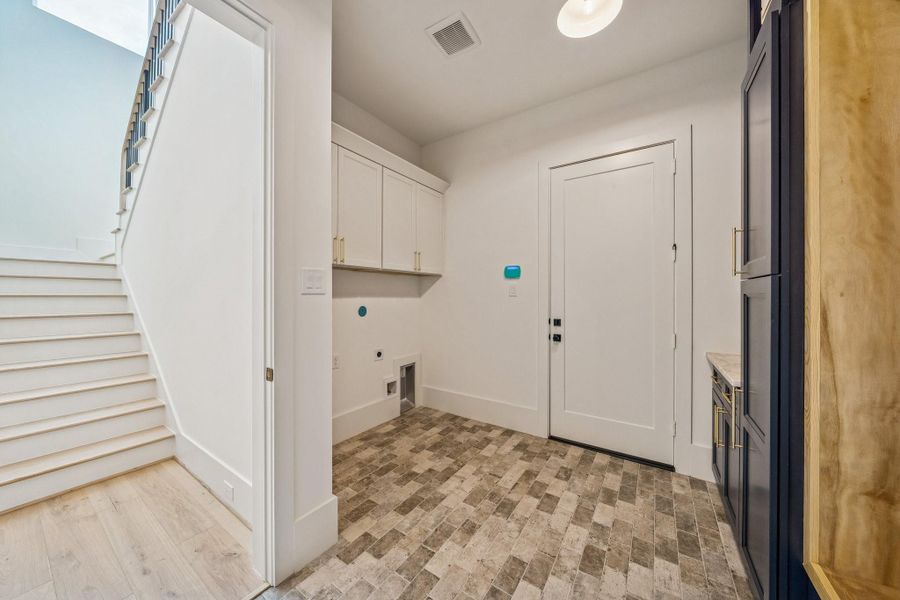 The washer and dryer has a home in the mudroom. Easy to access from the upstairs bedrooms as well as the primary.