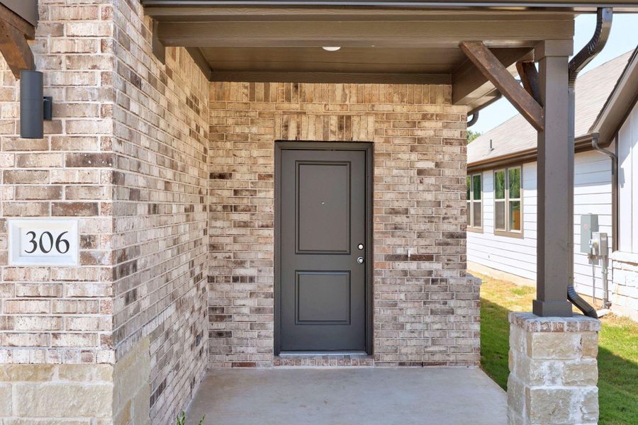 Front exterior of a new home in Trinity Ranch, Elgin, TX, highlighting curb appeal (Image 19).