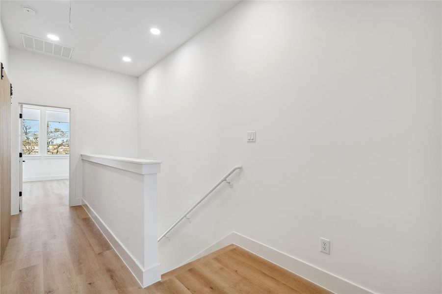 The upper hallway offers a seamless transition between rooms, enhanced by natural light and modern finishes.