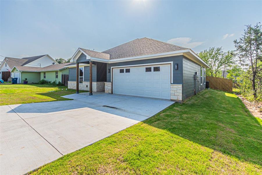 Ranch-style home with a garage and a front yard