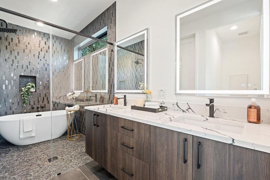 Bathroom featuring a shower stall, a freestanding tub, recessed lighting, double vanity, and granite tiled floors