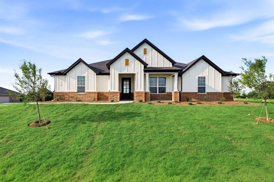Front exterior of a new home in Saddleback Estates, Boyd, TX, highlighting curb appeal (Image 1). Front exterior of a new home in Saddleback Estates, Boyd, TX, highlighting curb appeal (Image 1).