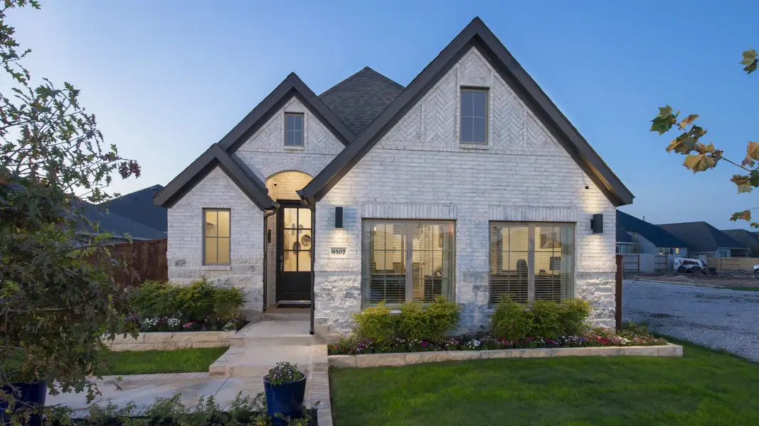 Front exterior of a new home in Woodhavyn, Magnolia, TX, highlighting curb appeal (Image 2).