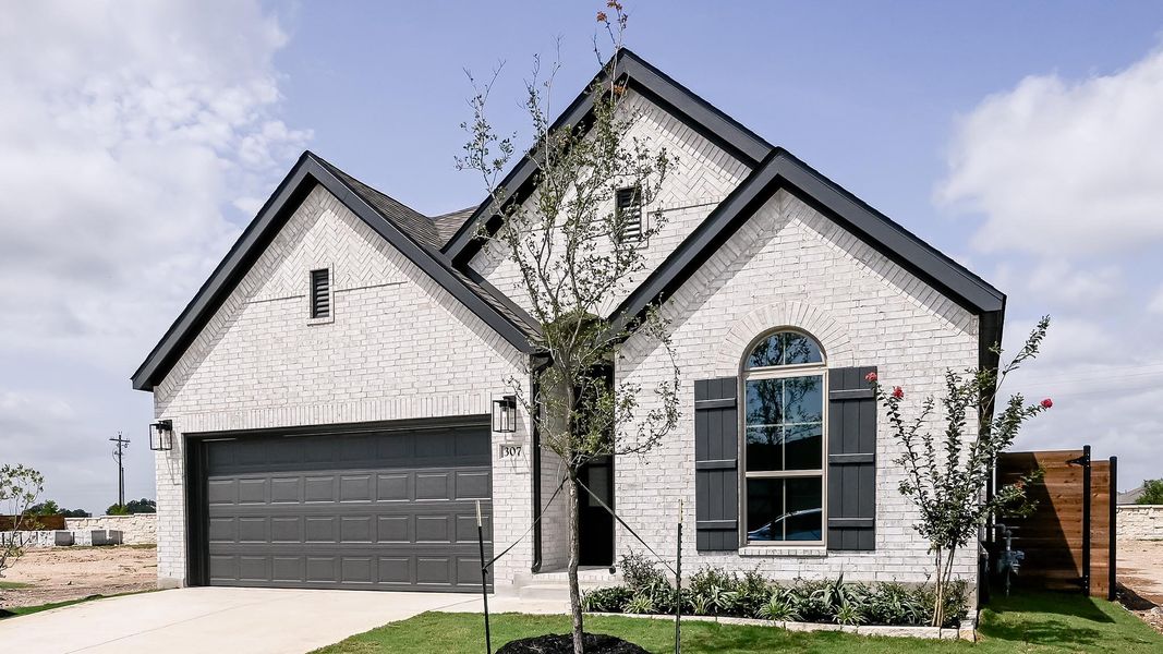 Front exterior of a new home in Juniper Springs, Lockhart, TX, highlighting curb appeal (Image 2). Front exterior of a new home in Juniper Springs, Lockhart, TX, highlighting curb appeal (Image 2).