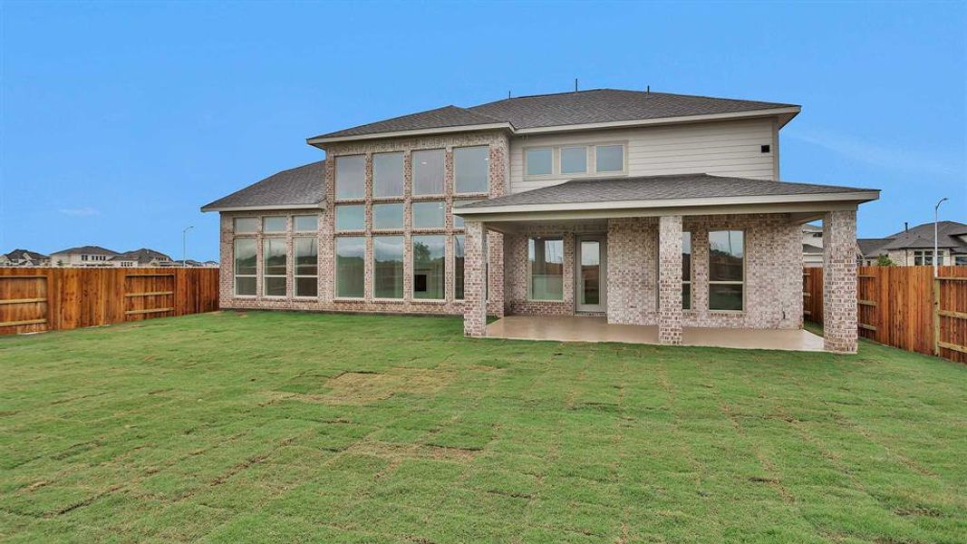 Front exterior of a new home in Valencia 70', Manvel, TX, highlighting curb appeal (Image 13).