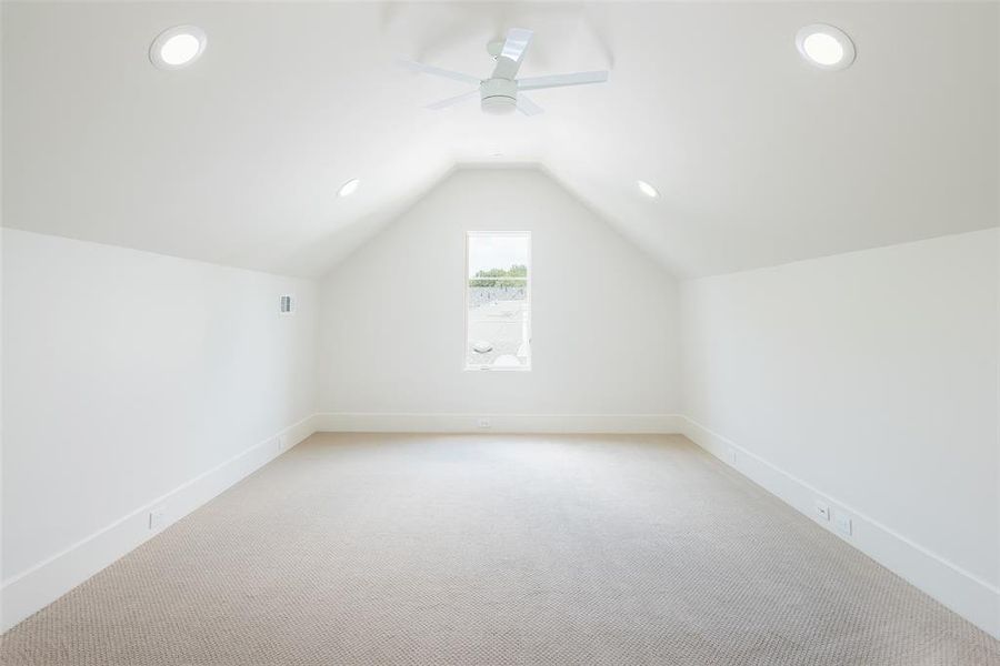 Bonus room with carpet, ceiling fan, and lofted ceiling