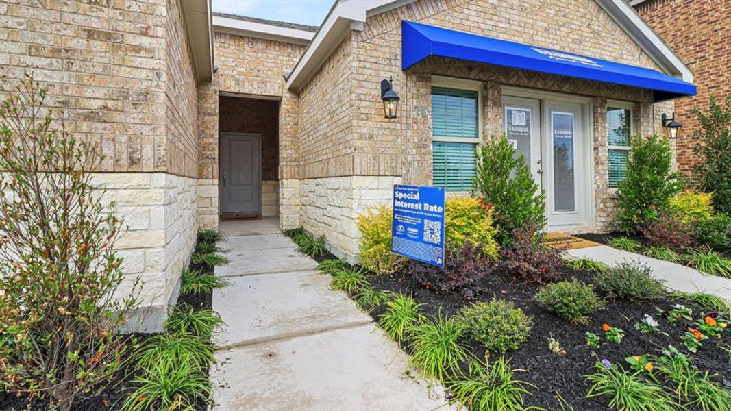 Property entrance with stone siding and brick siding