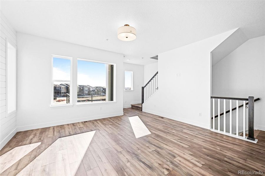Living room with 9ft ceilings and large windows.