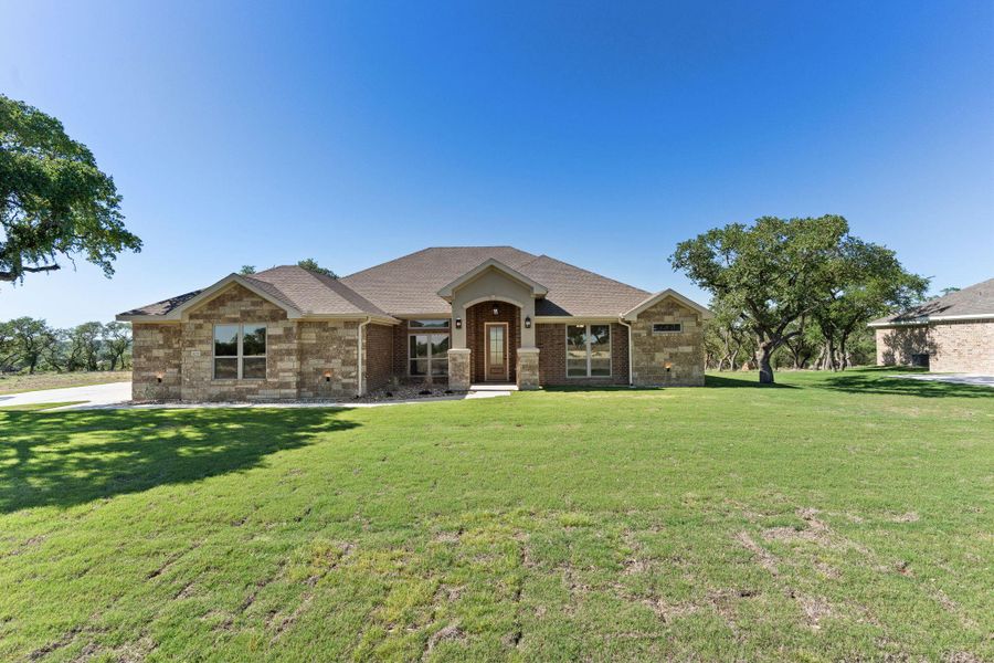 View of front of property featuring brick siding, a front lawn, and roof with shingles View of front of property featuring brick siding, a front lawn, and roof with shingles