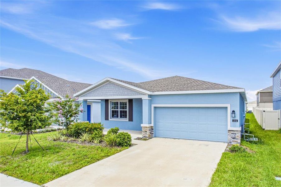Front exterior of a new home in Peace Creek Reserve, Winter Haven, FL, highlighting curb appeal (Image 22).