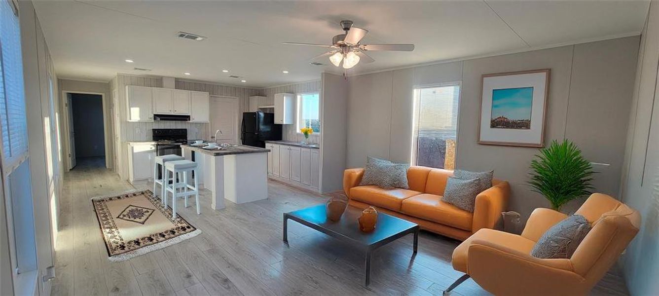 Living area featuring visible vents, ornamental molding, recessed lighting, light wood-style flooring, and a ceiling fan