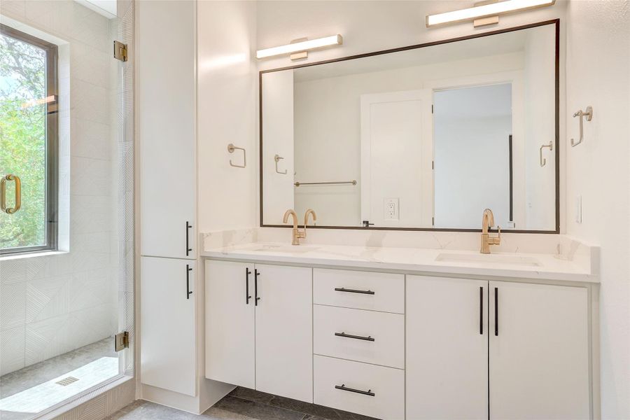 Bathroom with double vanity and a shower stall
