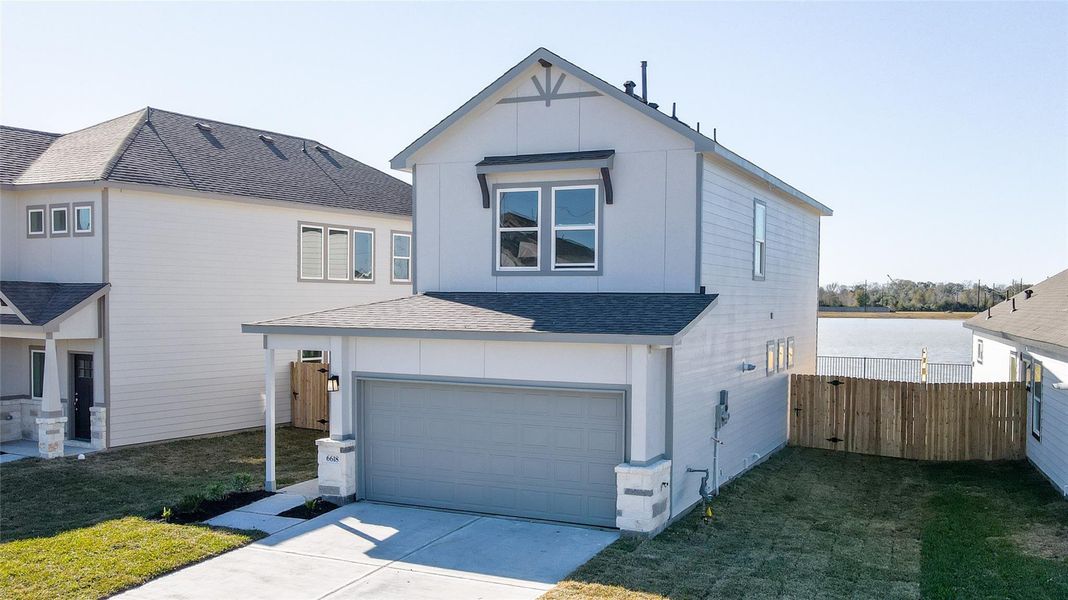 Modern two-story home with a clean exterior, featuring a two-car garage and a fenced backyard. Located near a body of water, offering potential scenic views. Ideal for families seeking a contemporary design. Modern two-story home with a clean exterior, featuring a two-car garage and a fenced backyard. Located near a body of water, offering potential scenic views. Ideal for families seeking a contemporary design.