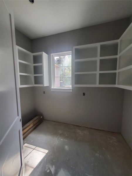HUGE WALK-IN PANTRY WITH A WINDOW AT THE FRONT OF THE HOME ( PRE- CABINET INSTALLATION)