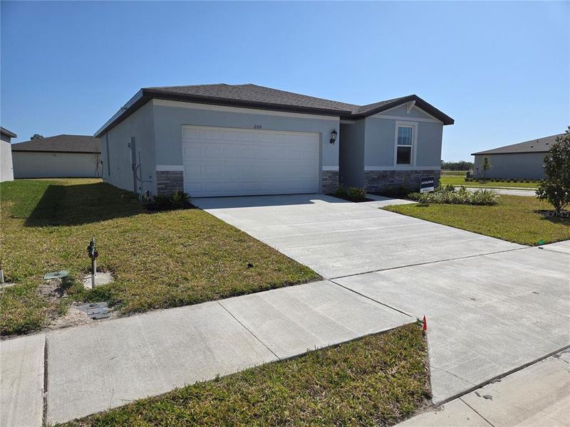 Front exterior of a new home in Magnolia Bay - Classic Series, Nokomis, FL, highlighting curb appeal (Image 14).