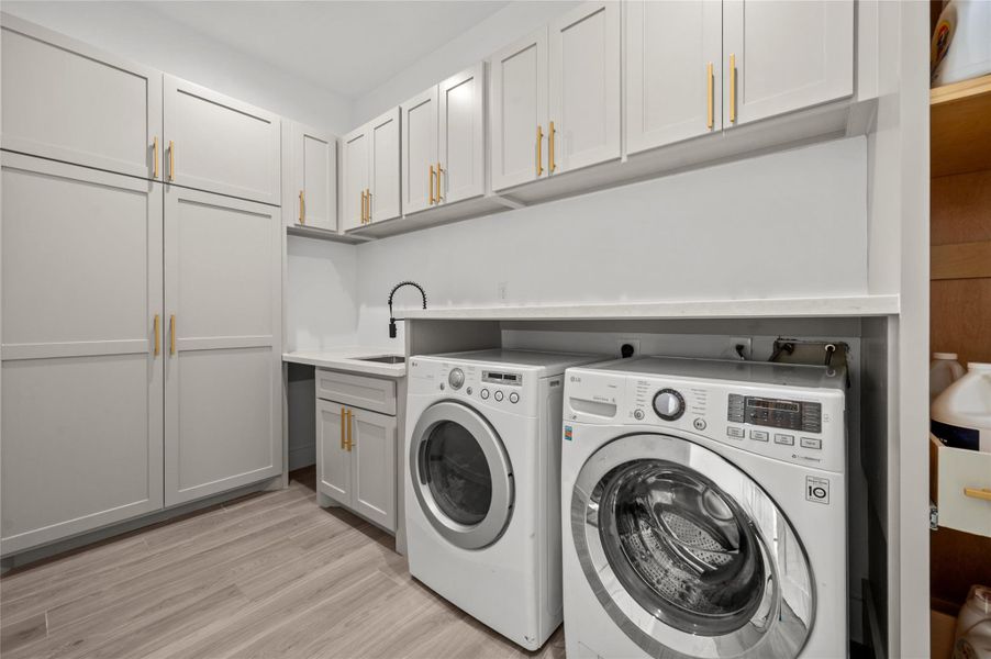 Tis utility room features custom cabinetry