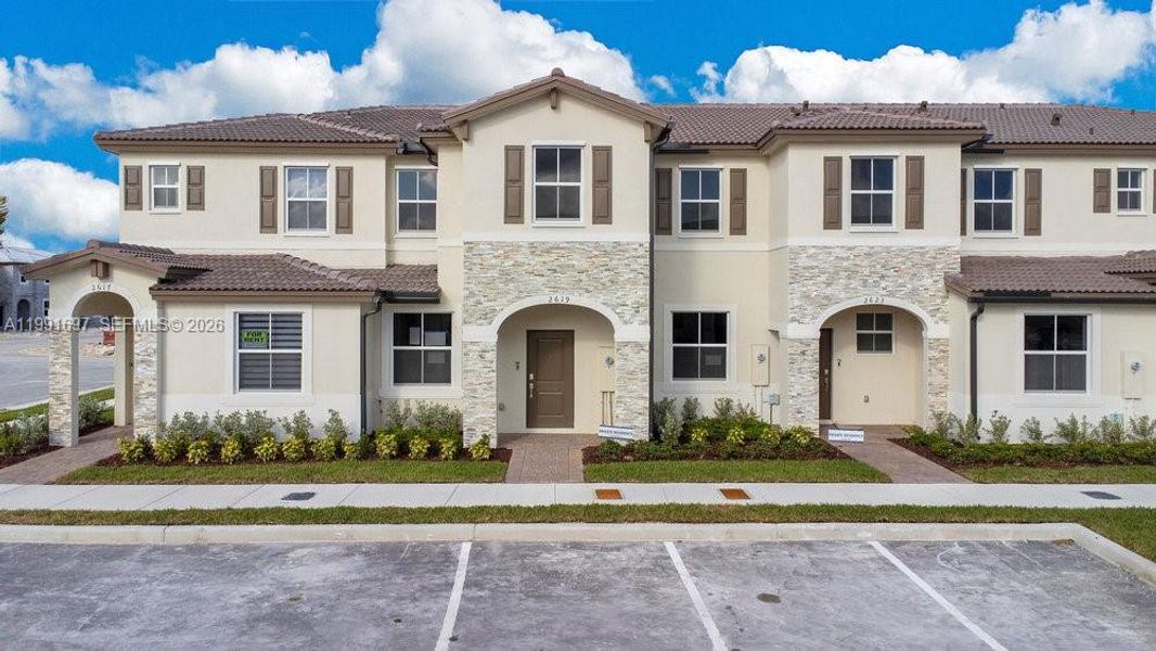 Front exterior of a new home in , Homestead, FL, highlighting curb appeal (Image 1). Front exterior of a new home in , Homestead, FL, highlighting curb appeal (Image 1).