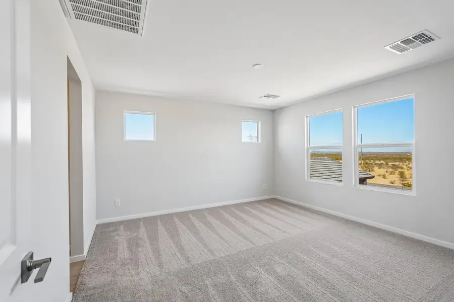 A room with a window and a carpet.