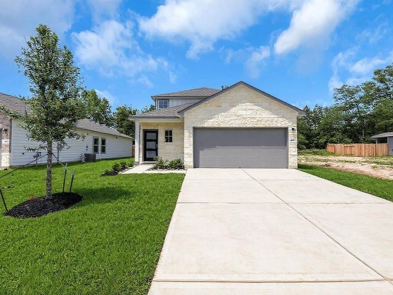 Front exterior of a new home in Caney Creek Place, Conroe, TX, highlighting curb appeal (Image 2).
