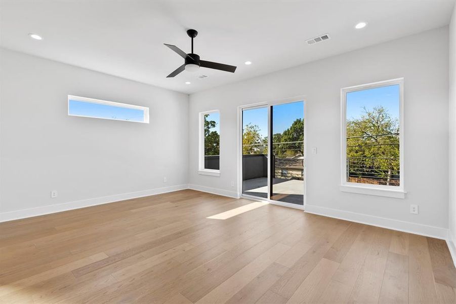 Unfurnished room with light hardwood / wood-style floors and ceiling fan