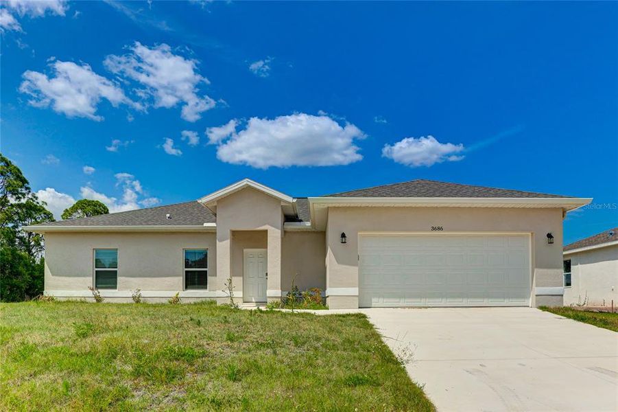 Front exterior of a new home in , North Port, FL, highlighting curb appeal (Image 1). Front exterior of a new home in , North Port, FL, highlighting curb appeal (Image 1).