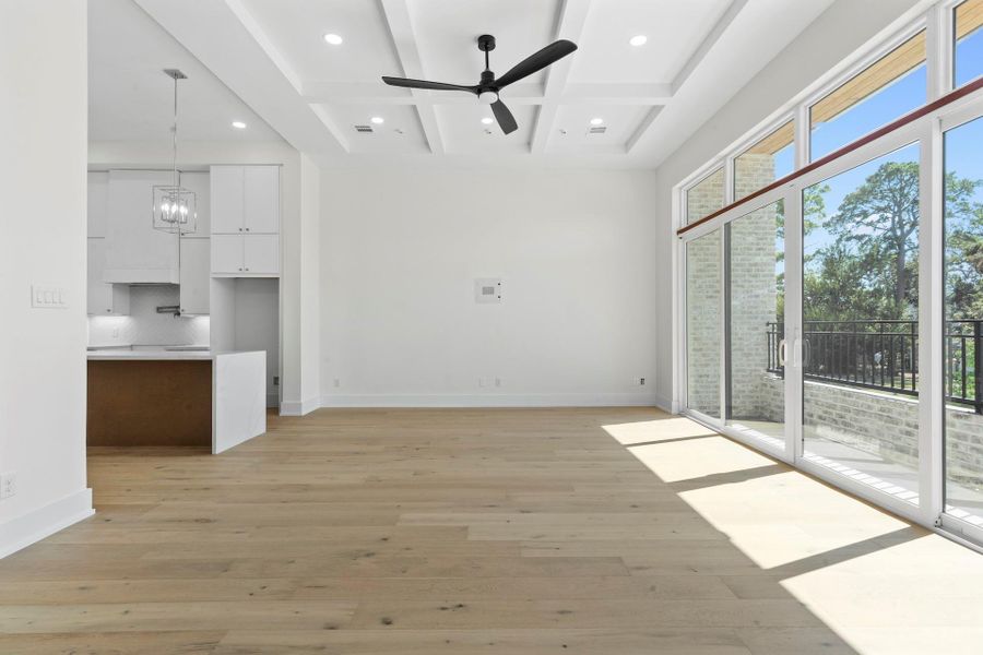 Your view from the dining room to the living room with access to your balcony. -  Come tour our furnished model home open Saturday & SundayEstimated completion November 30, 2025.