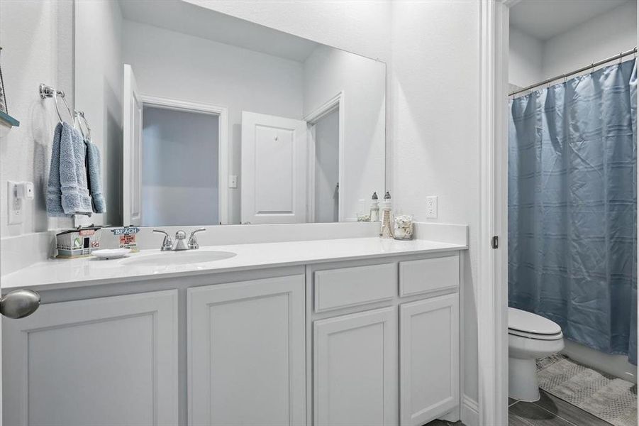 Full bathroom featuring vanity and a shower with curtain