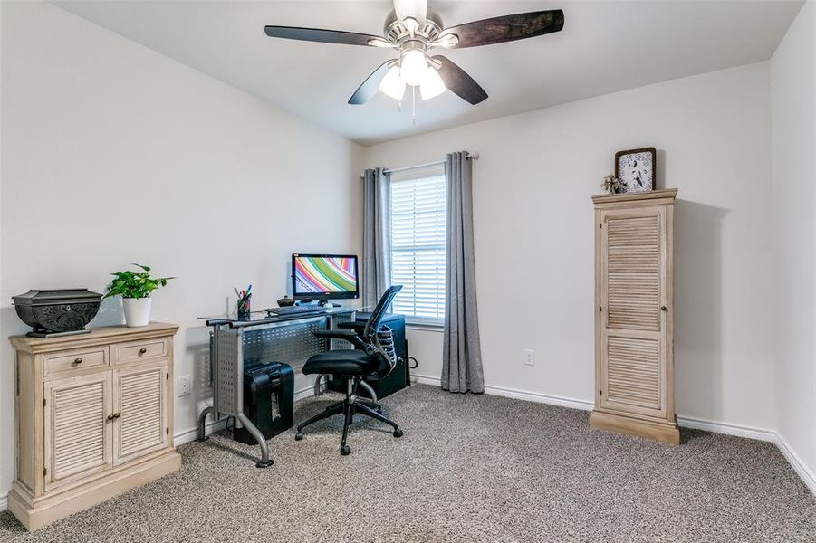 Office with ceiling fan and carpet flooring