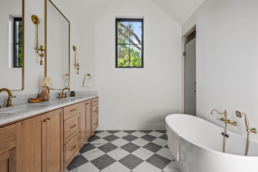 Marble countertops and a freestanding tub create a serene and functional bathroom retreat.