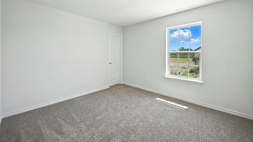 Carpeted empty room featuring baseboards Carpeted empty room featuring baseboards