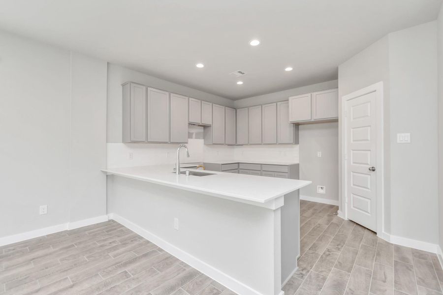 The open concept effortlessly connects the kitchen to the expansive family room, forming a perfect hub for gatherings. This seamless flow creates an inviting space where cooking and socializing come together harmoniously. Sample photo of completed home with similar floor plan. Actual colors and selections may vary.