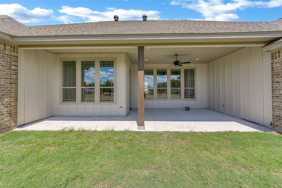 Rear view of house featuring a patio area, a yard, and ceiling fan