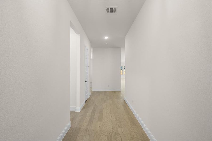 Corridor featuring light wood-style flooring and recessed lighting