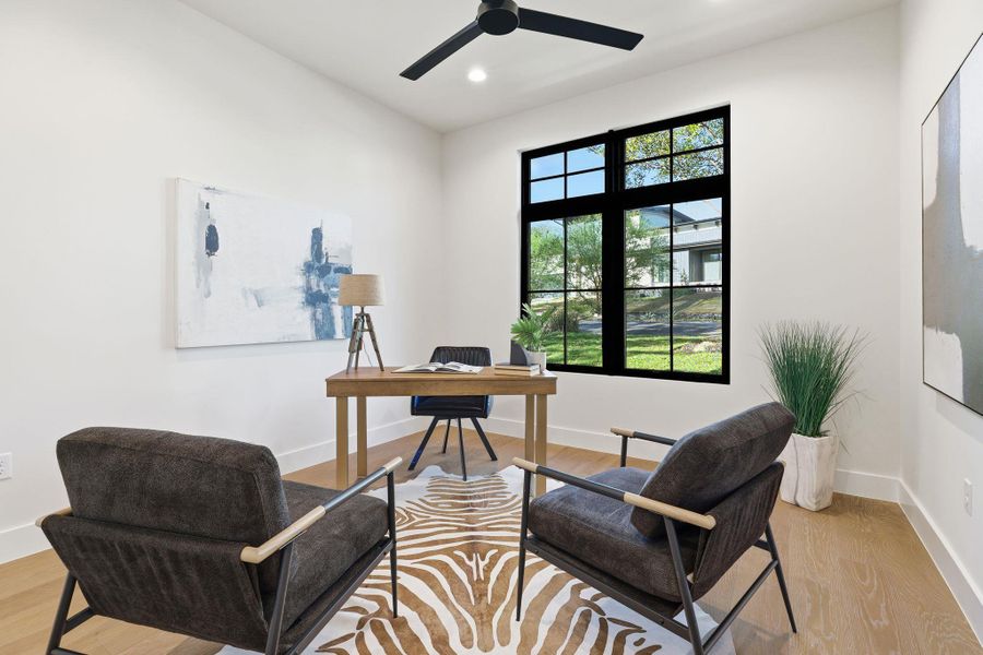 Office area with light wood-type flooring, recessed lighting, and a ceiling fan