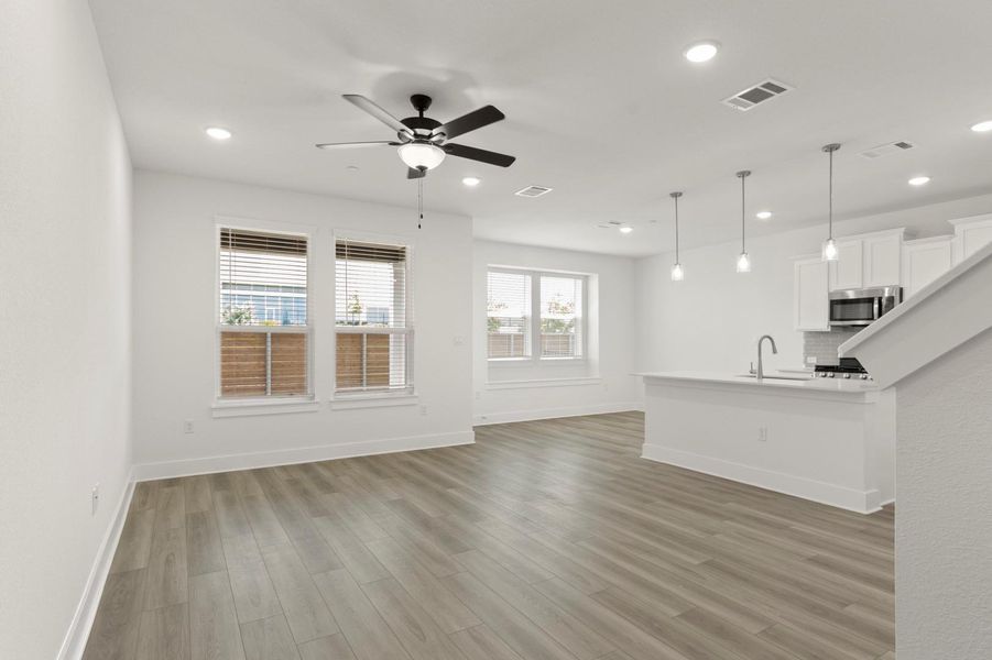 Unfurnished living room featuring light wood finished floors, recessed lighting, and ceiling fan