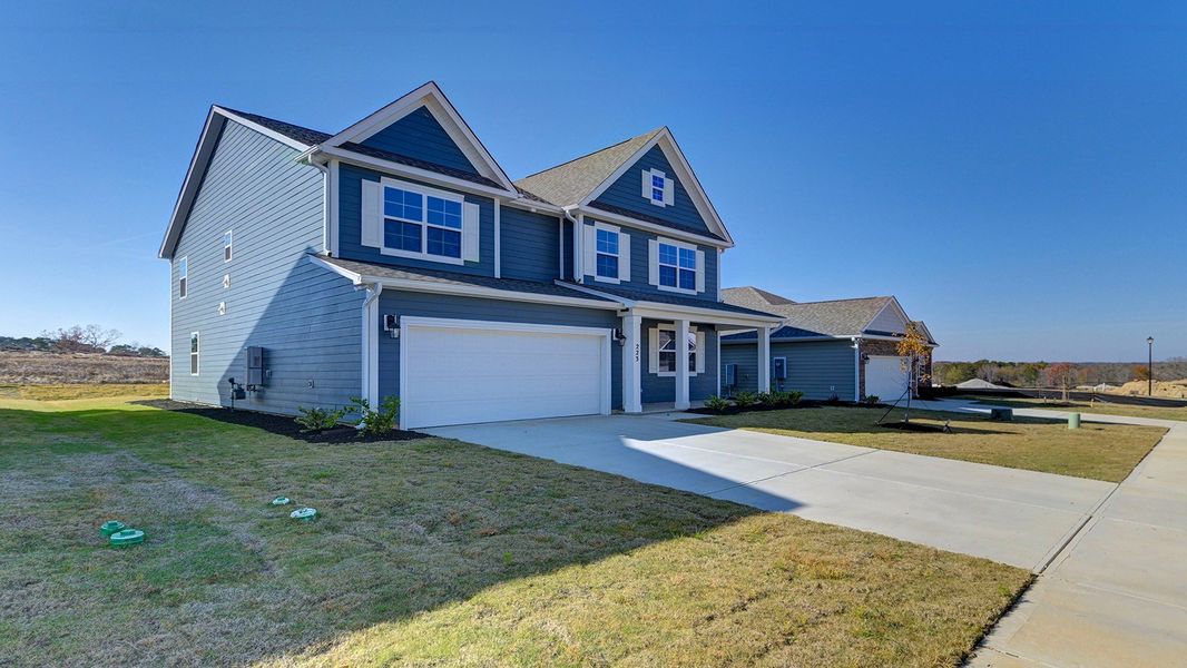 Front exterior of a new home in Livingston Woods, Irmo, SC, highlighting curb appeal (Image 27). Front exterior of a new home in Livingston Woods, Irmo, SC, highlighting curb appeal (Image 27).