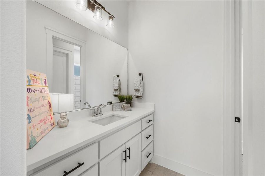 Bathroom featuring vanity and tile patterned flooring