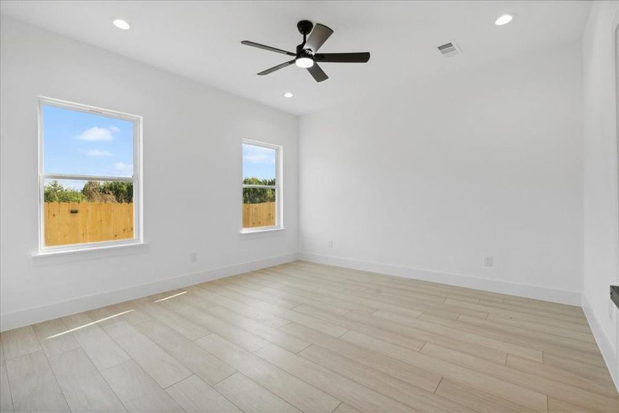 Unfurnished room with light hardwood / wood-style flooring and ceiling fan