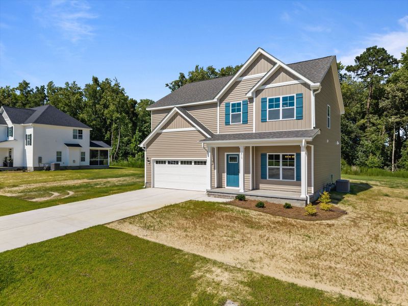 Front exterior of a new home in Laurel Oaks, Greenville, NC, highlighting curb appeal (Image 22). Front exterior of a new home in Laurel Oaks, Greenville, NC, highlighting curb appeal (Image 22).