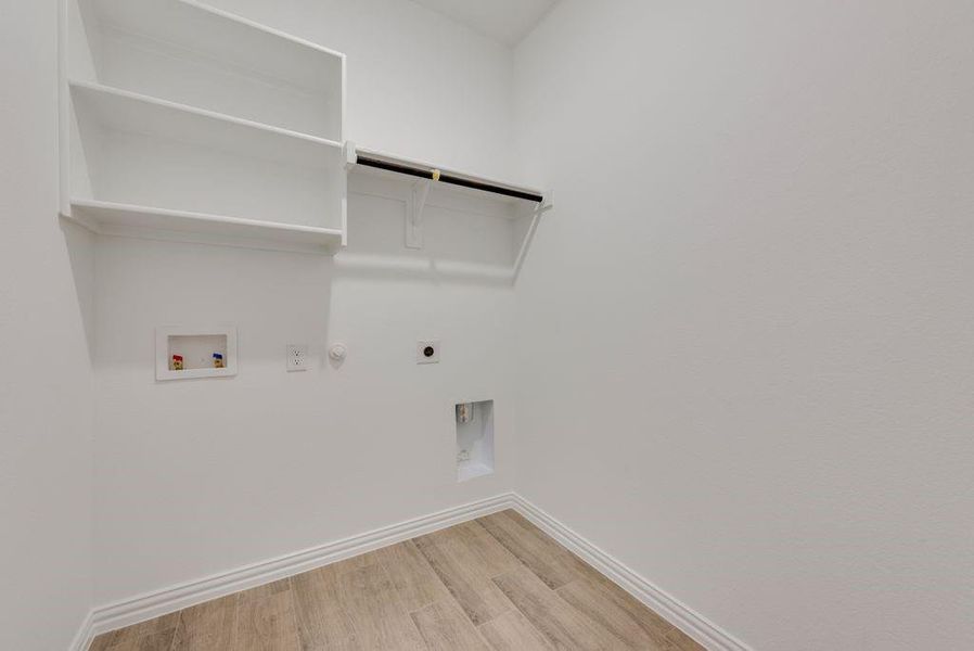 Washroom featuring gas dryer hookup, hookup for a washing machine, electric dryer hookup, and light wood-type flooring