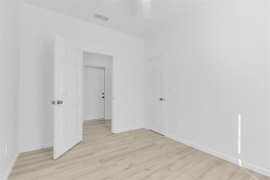 Spare room featuring light wood-type flooring and a ceiling fan