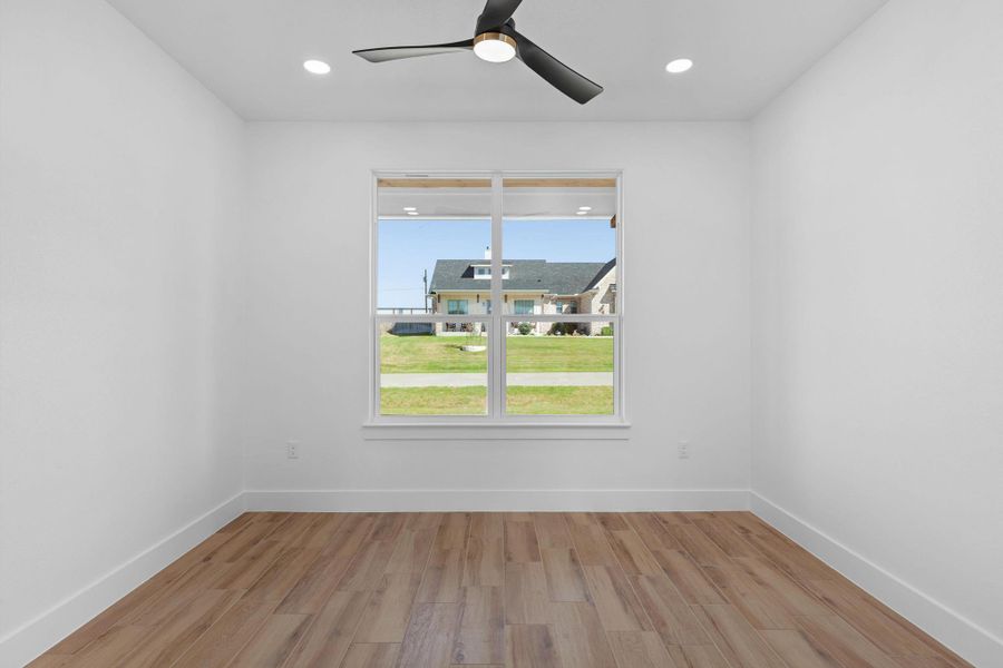Empty room with light wood finished floors, a ceiling fan, and recessed lighting Empty room with light wood finished floors, a ceiling fan, and recessed lighting
