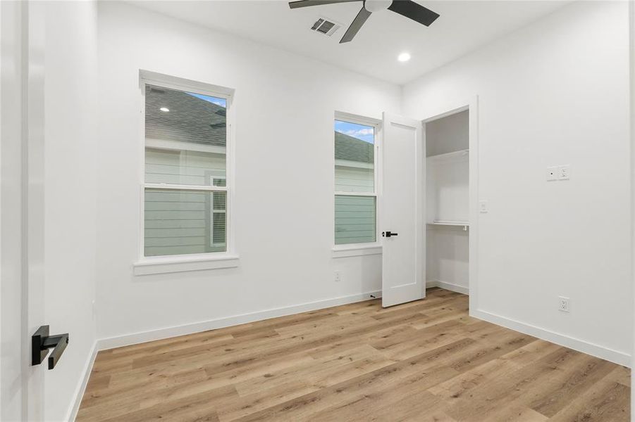 Spare room featuring light wood-type flooring and ceiling fan